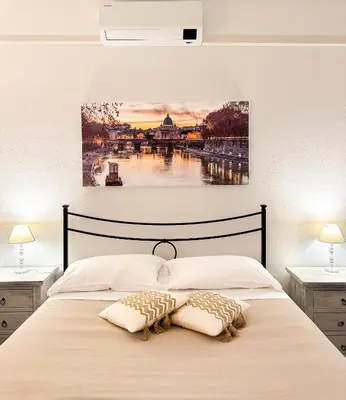 a bedroom with a bed with a painting on the wall at Cozy Home San Giovanni in Rome