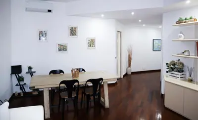 a dining room with a wooden table and chairs at Cozy Home San Giovanni in Rome