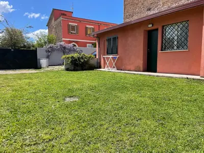 a yard in front of a house with a green lawn at BORGO PESCI in Rome