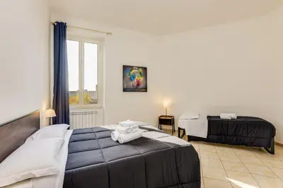 a bedroom with two beds and a window at Magenta Tiburtino in Rome