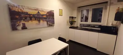 a kitchen with a counter and a table and a window at Casa Felicita in Rome