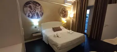 a hotel room with a bed and a mirror at Casa Felicita in Rome
