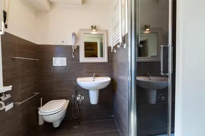 a bathroom with a toilet and a sink and a shower at Casa Felicita in Rome