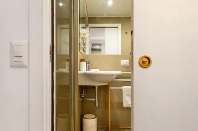 a bathroom with a sink and a mirror at Trevi Apartment in Rome