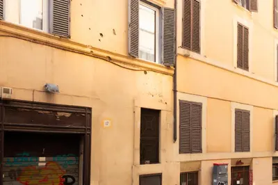 a building with windows and shutters on it at Trevi Apartment in Rome