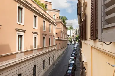 a street with cars parked on the side of a building at Trevi Apartment in Rome
