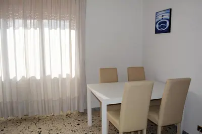 a white table with two chairs and a window at La Casa di Dany in Rome