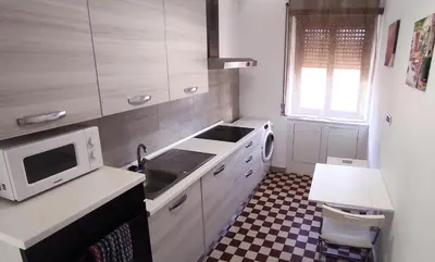 a small kitchen with a sink and a microwave at La Casa di Dany in Rome
