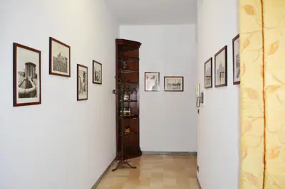 a hallway with framed pictures on the walls at La Casa di Dany in Rome
