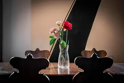a vase of flowers sitting on top of a table at Dimora degli Acetari in Rome
