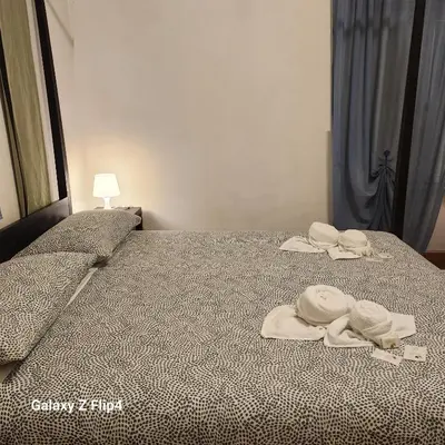 a bedroom with a bed with towels on it at SweetHouseVittorio in Rome