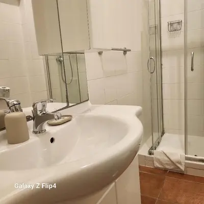 a white bathroom with a sink and a shower at SweetHouseVittorio in Rome