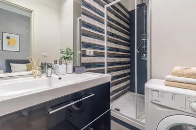 a bathroom with a sink and a washing machine at BND Boutique Gemelli Vaticano in Rome