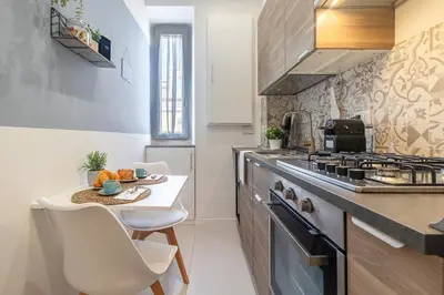 a small kitchen with a table and a stove at BND Boutique Gemelli Vaticano in Rome