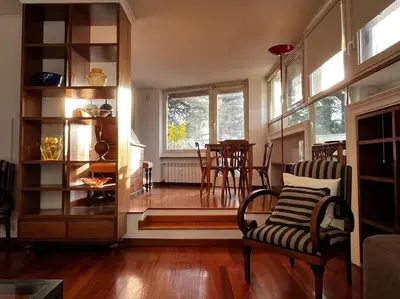 a living room with a couch and a chair and a window at Open space Apartment in Prati in Rome