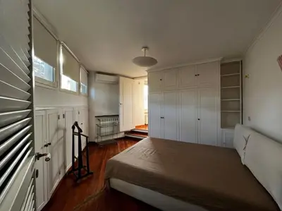 a bedroom with white cabinets and a bed in it at Open space Apartment in Prati in Rome