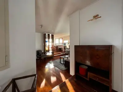 a living room with a couch and a tv at Open space Apartment in Prati in Rome