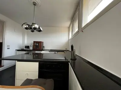 a kitchen with a black counter top and a stove at Open space Apartment in Prati in Rome