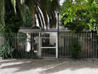 a fence with a gate in front of a building at Open space Apartment in Prati in Rome