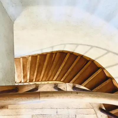 a spiral staircase in a building with wooden ceilings at Open space Apartment in Prati in Rome