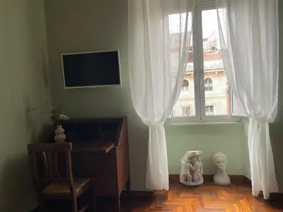 a living room with a television and a window at Prope Vaticanum in Rome