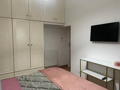 a bedroom with a bed and a flat screen tv at Prope Vaticanum in Rome