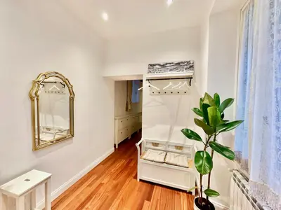 a dressing room with a mirror and a plant at Vacanze Romane Laterano in Rome