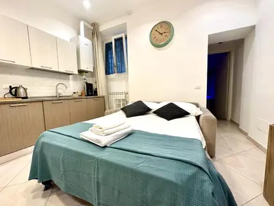 a bedroom with a bed with a clock on the wall at Vacanze Romane Laterano in Rome