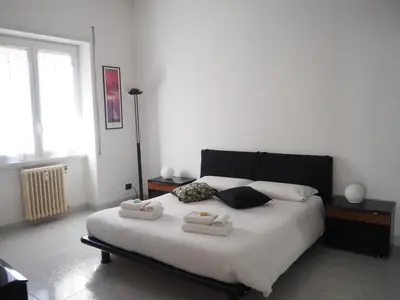 a bedroom with a large bed with two towels on it at Appartamento Vacanze Romane in Rome