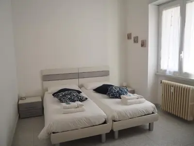 a bedroom with two beds with towels on them at Appartamento Vacanze Romane in Rome