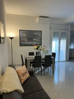 a living room with a couch and a table with chairs at Appartamento Vacanze Romane in Rome