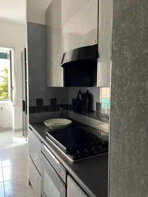 a kitchen with a stove and a counter top at Appartamento Vacanze Romane in Rome