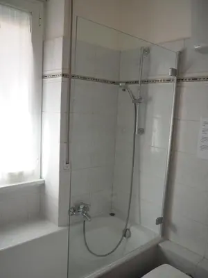 a bathroom with a shower with a glass door at Appartamento Vacanze Romane in Rome
