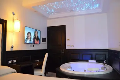 a room with a bath tub in a bedroom at Vaticano Royal Suite Guest House in Rome