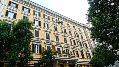 a large yellow building with a lot of windows at Vaticano Royal Suite Guest House in Rome