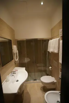 a bathroom with a shower and a sink and a toilet at Vaticano Royal Suite Guest House in Rome