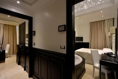 a bedroom with a bed and a mirror and a bathroom at Vaticano Royal Suite Guest House in Rome