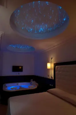 a bedroom with a bed and a tub in a room at Vaticano Royal Suite Guest House in Rome