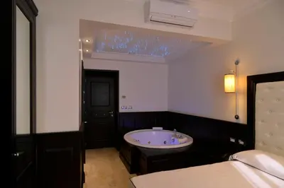 a bathroom with a tub in the corner of a room at Vaticano Royal Suite Guest House in Rome