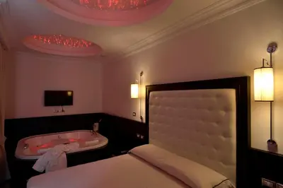 a bedroom with a tub and a bed and a bed and a bed at Vaticano Royal Suite Guest House in Rome