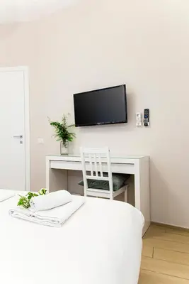 a room with a desk with a tv and a chair at B&B Casetta Roma in Rome