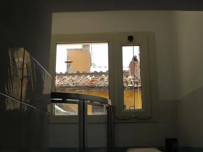 a room with two windows and a view of a building at Casa Micheli in Centro ex Frattina Luxury Apartment in Rome