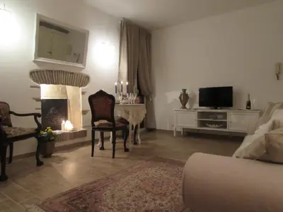 a living room with a fireplace and a table with a television at Casa Micheli in Centro ex Frattina Luxury Apartment in Rome