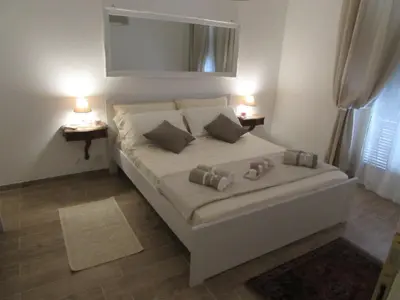 a bedroom with a bed with two lamps on two tables at Casa Micheli in Centro ex Frattina Luxury Apartment in Rome