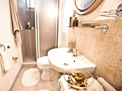 a small bathroom with a sink and a toilet at SottosopraSannio in Rome