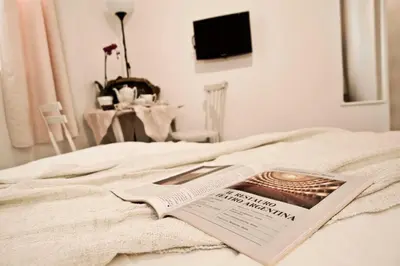 a magazine sitting on top of a bed at SottosopraSannio in Rome