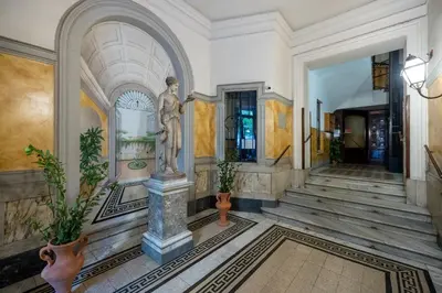 a building with a statue in the middle of a hallway at Little Gaia Suite in Rome