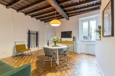 a living room with a white table and chairs at Rome As You Feel - Santa Margherita Design Apartment in Rome