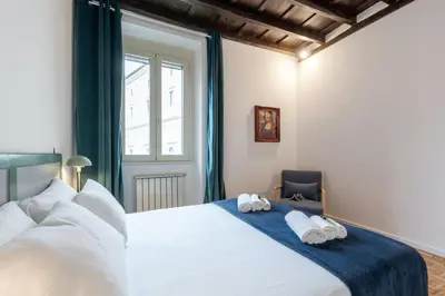 a bedroom with a large white bed with towels on it at Rome As You Feel - Santa Margherita Design Apartment in Rome