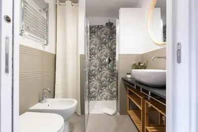 a bathroom with a sink and a toilet and a shower at Rome As You Feel - Santa Margherita Design Apartment in Rome